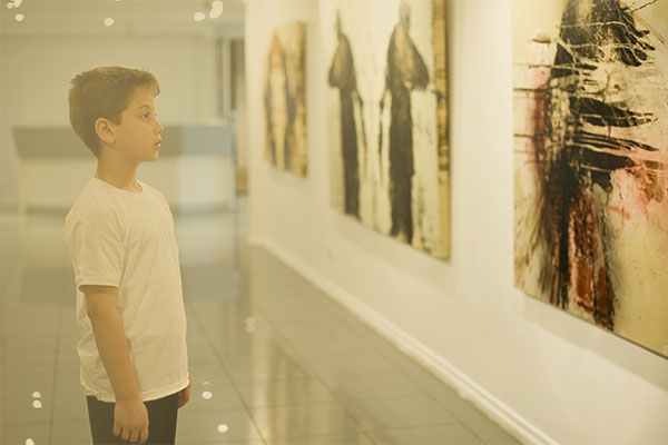 boy looking at art in a gallery