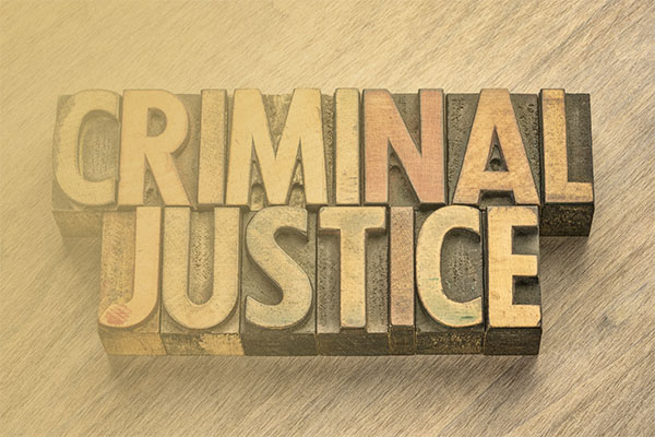 printing block letters spelling out "criminal justice"