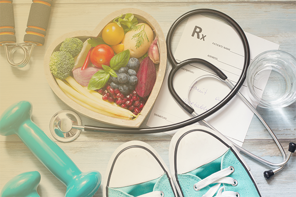 Image of a table with items on it including sneaker, a stethoscope, weight, and a fruit plate