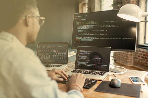 programmer at computer writing code