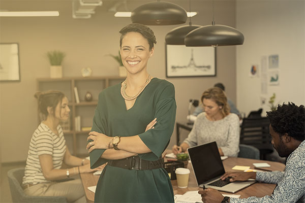 confident female leader in conference room with staff