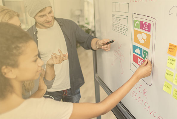 team of creative professionals at whiteboard